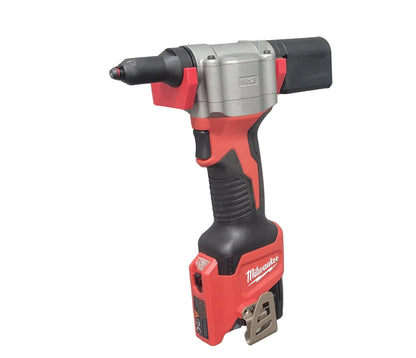 Red and black Milwaukee M12 Rivet tool on a white background