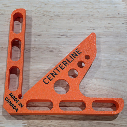 Orange centerline tool with 'Made in Canada' text on a wooden surface